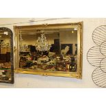 A rectangular wall mirror in a gilt effect frame