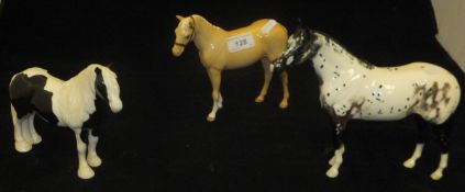 A collection of three various Beswick horse figures including palomino with plaited tail,