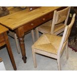 A rectangular pine dining table with drawers, raised on turned legs,