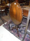 A 19th Century mahogany oval tilt-top table with pie-crust edge,