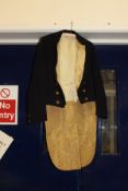 A Beaufort Hunt navy hunt jacket with brass buttons,