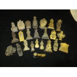 A box containing 24 various Victorian letter clips to include three by Merry,