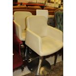 A pair of modern cream upholstered adjustable bar chairs by REM,