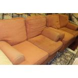 A pair of modern two seat sofas in terracotta upholstery