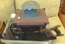 A box containing various metal wares including exterior lantern, cast iron door stops, two saws,