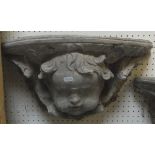 A pair of composition cherubic mask wall brackets
