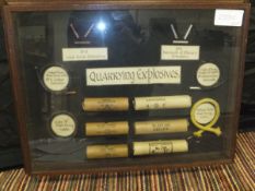 Framed and glazed items relating to quarrying explosives, vintage packaging and fuses.