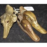 A collection of three brass letter clips, two in the form of duck heads each set with glass eyes,