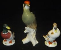 A collection of three various bird figurines including Karl Ens "Green Woodpecker",