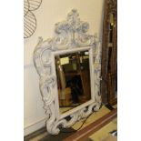 A rectangular wall mirror with large thick molded acanthus leaf frame