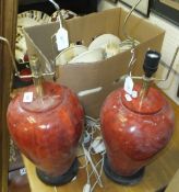 Two vintage leather suitcases and a pair of table lamps