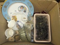 A box of various brass door furniture, commemorative china, glass jelly moulds, various trinkets,