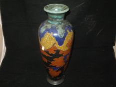 A Gouda pottery vase polychrome decorated with autumnal leaves, inscribed "Tiny Gouda ...