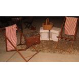 A pair of deck chairs, a pair of white units with baskets beneath,