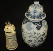 A Delft blue and white vase and cover and a Webco stein of figural form