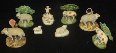 A collection of eight various Staffordshire sheep figures including two ewe and ram spill vases,