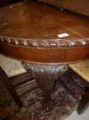 A circa 1920 mahogany oval extending dining table on carved cabriole legs to claw and ball feet,