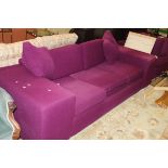 An HB Design corner sofa in plum upholstery