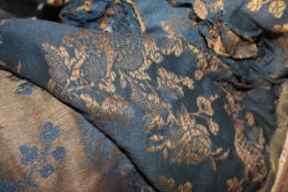 A box containing a selection of Edwardian blue and gold floral fabric,