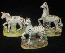 Three various Staffordshire pottery Zebra figures CONDITION REPORTS The two zebras