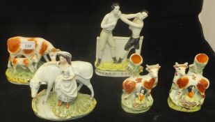 Two 19th Century Staffordshire cow and milkmaid spill vases, a cow and calf figure,