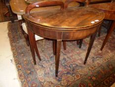 An early 19th Century mahogany tea table of demi-lune form,