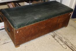 A pine ottoman with leather top containing various curtains, material,