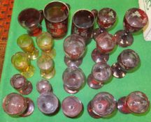 A collection of Bohemian overlaid glass ware to include various stemmed drinking glasses and two