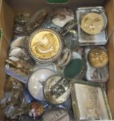 A box of various decorative paperweights