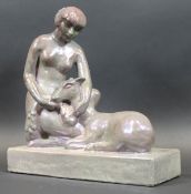 An Art Deco lustre pottery figure of a woman seated with doe on a plinth base, 38.5 cm x 36.