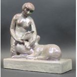 An Art Deco lustre pottery figure of a woman seated with doe on a plinth base, 38.5 cm x 36.