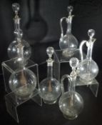 A set of three 19th Century glass stoppered ewers,