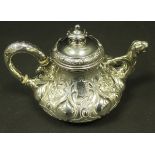 A Victorian silver teapot of bulbous form with profusely embossed decoration,