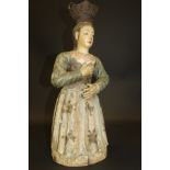 An 18th Century Continental carved and painted wood figure of maiden in a blue dress,