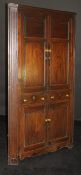 A 19th Century oak corner cupboard with two fielded panel doors enclosing three shelves over two