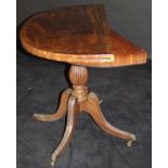 A Regency mahogany and inlaid tea table, with demi-lune fold-over top,