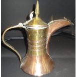 A 19th Century Turkish copper and brass coffee pot with tapering brass finial and cylindrical brass