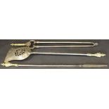 A set of three 19th Century fire irons to include shovel, poker and tongs, with brass handles,