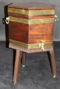 A George III mahogany and brass bound cellarette of hexagonal form with two brass carry handles,