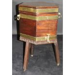 A George III mahogany and brass bound cellarette of hexagonal form with two brass carry handles,