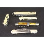 A collection of ivorine and ivory cased pocket knives including a Swiss flag decorated knife,