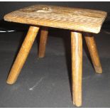 A 19th Century elm four legged milking stool with rectangular top and cylindrical legs, 16.