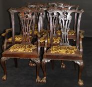 A set of eight Edwardian mahogany dining chairs in the Chippendale taste with drop-in seats on