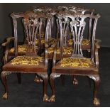 A set of eight Edwardian mahogany dining chairs in the Chippendale taste with drop-in seats on