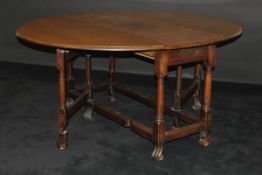 A 19th Century walnut oval gate-leg drop-leaf dining table in the circa 1700 Flemish manner,