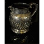 WITHDRAWN A George II silver jug with gadrooned base raised on circular stepped foot (bears maker's