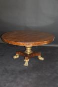 A 19th Century mahogany and circular breakfast table the plain top above a gilded pedestal,