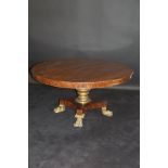 A 19th Century mahogany and circular breakfast table the plain top above a gilded pedestal,