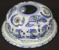 A 19th Century French tin-glazed pottery inkwell with all over butterfly and scrolling foliate