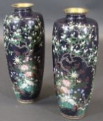 A pair of Japanese cloisonne vases featuring birds amongst blossoming foliage and a blossoming tree,